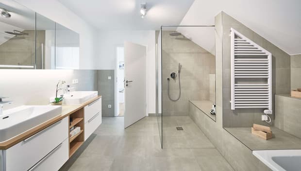 Modernes Badezimmer mit begehbarer Dusche, Doppelwaschbecken, großem Spiegel, Handtuchheizkörper und heller Fliesengestaltung.