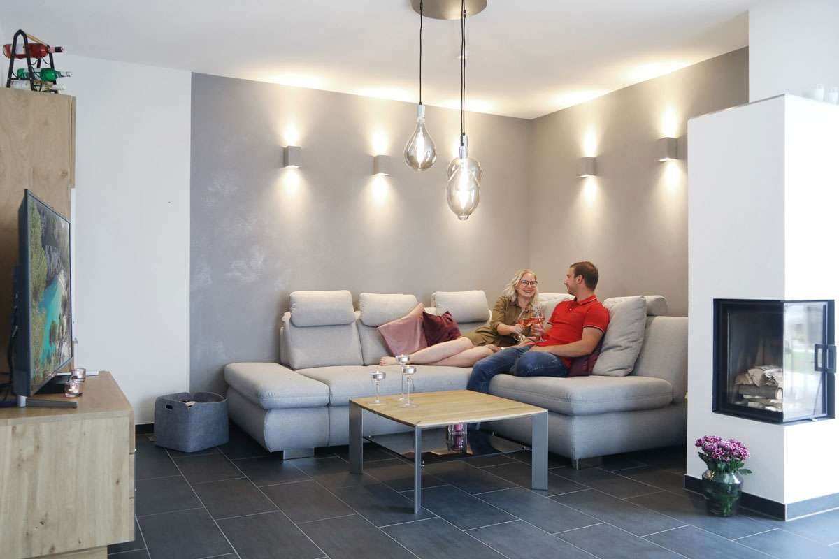 Wohnzimmer mit Sitzecke, Kamin und Fernseher