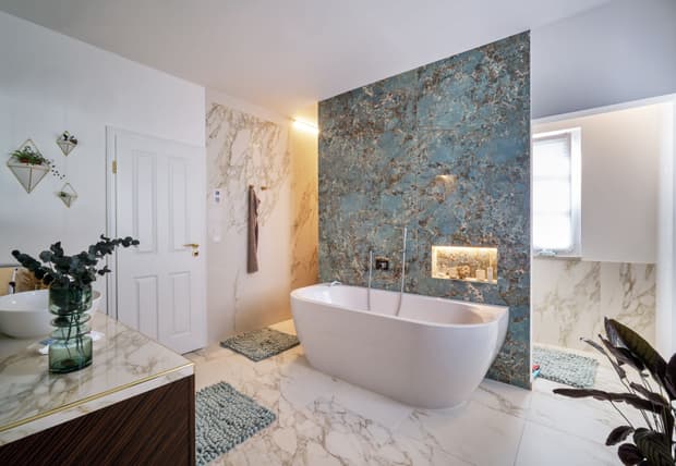 Das edle Badezimmer des modernen, mediterranen Holzhauses im Stil einer Stadtvilla mit weißem, mineralischem Außenputz und grünen Fensterläden