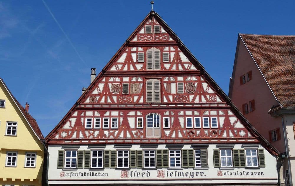Historisches Fachwerkhaus mit rotem Gebälk und Schindeldach in Altstadt, zeigt traditionelle deutsche Architektur und denkmalgeschütztes Gebäude.