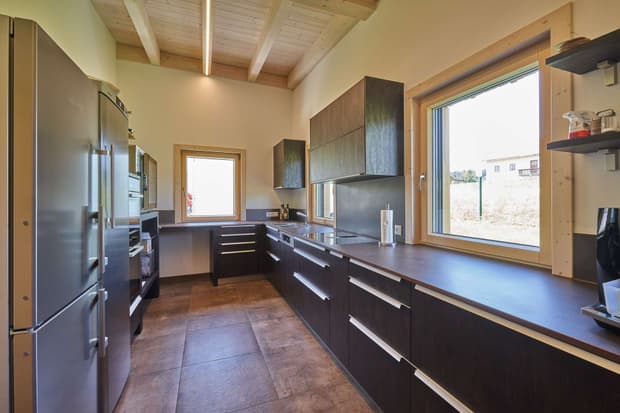 Die Küche des modernen Pfahlbaus aus Holz mit vertikaler Lärchenverschalung, der als Mitarbeiterlounge dient