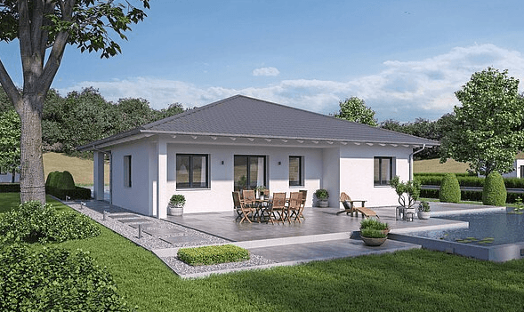 Moderner weißer Bungalow mit grauem Satteldach Terrasse mit Holz-Gartenmöbeln und angrenzendem Pool im grünen Garten